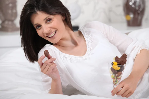 Woman holding a glass full with Easter eggs — Stock Photo, Image