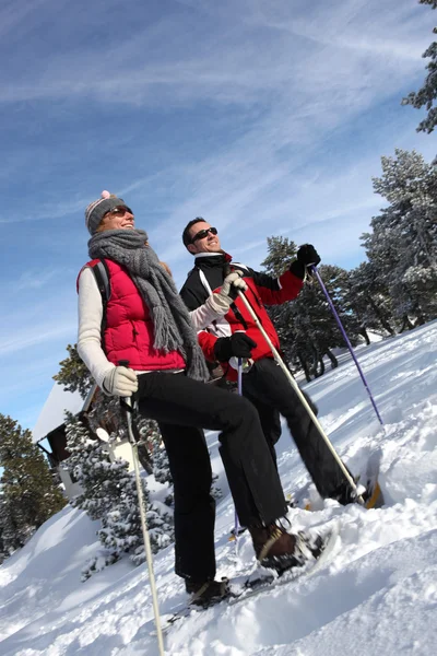 Coppia escursioni attraverso la neve — Foto Stock