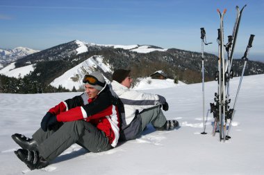 Skiers sitting in the snow clipart