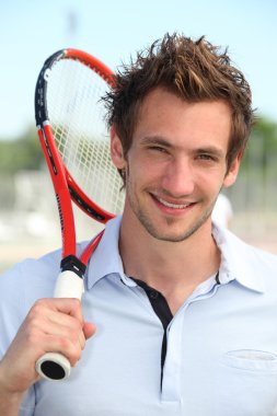 Male tennis player holding racquet over shoulder clipart