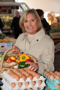 Woman shopping at local market clipart