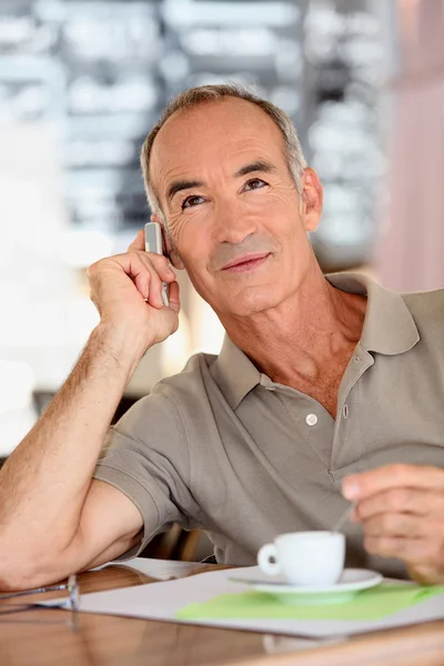 A 65 years old man looking dynamic is calling — Stock Photo, Image