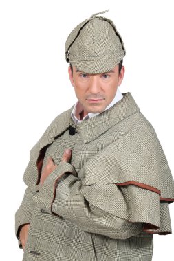 Man dressed like Sherlock Holmes and looking at us. clipart