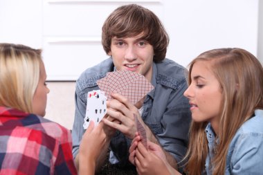 Teenagers playing cards clipart