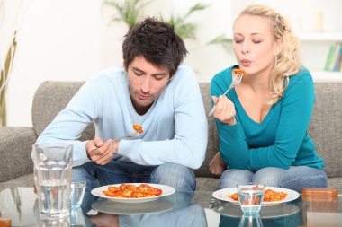 Couple eating meal at home clipart