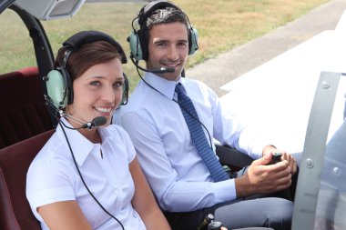 Man and woman in the cockpit of a light aircraft clipart