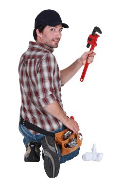 Plumber holding a pipe wrench clipart