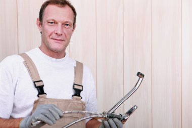 Plumber holding a faucet clipart