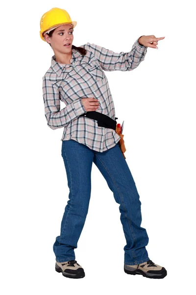 A disgusted female construction worker pointing at something. — Stock Photo, Image