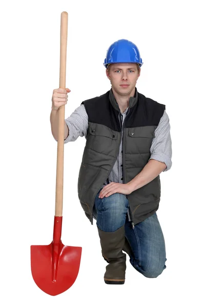 Worker clutching shovel — Stock Photo, Image