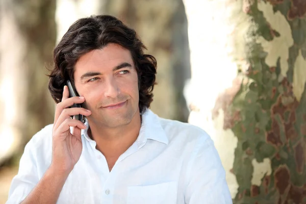 Man making call in park — Stock Photo, Image