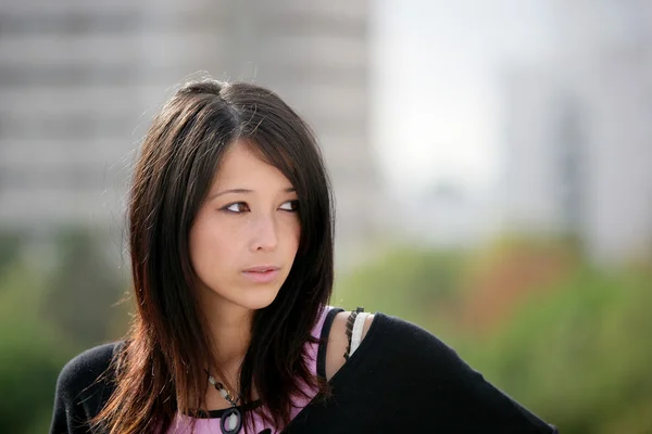 Portrait of Eurasian girl outdoors — Stock Photo, Image
