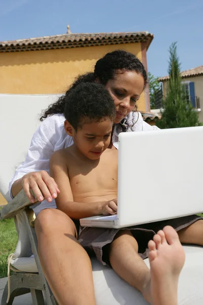Mother with kid using computer — Stock Photo, Image