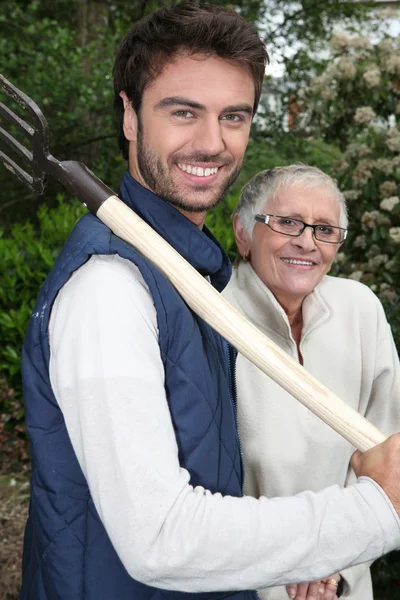 Senior with gardener and fork — Stock Photo, Image