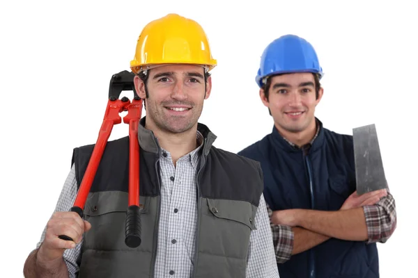 Hantverkare och lärling poserar tillsammans — Stockfoto