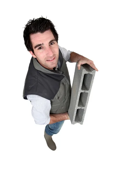 Bricklayer with a block — Stock Photo, Image