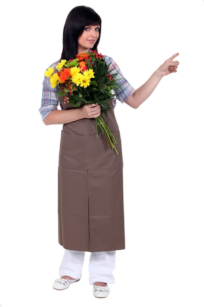 Florist pointing off camera — Stock Photo, Image