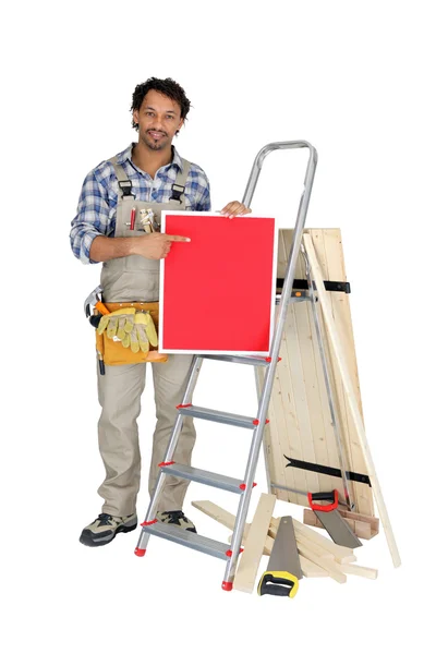 Builder holding up a blank sign — Stock Photo, Image