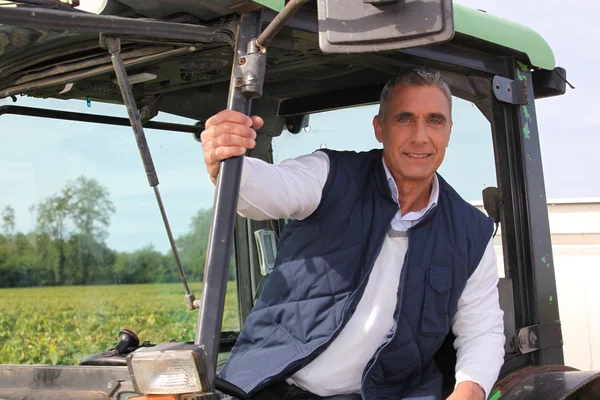 Farmer in the cab of his tractor — Stok fotoğraf