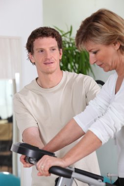 Personal trainer with his client clipart