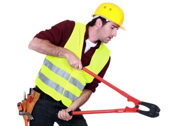 Tradesman using a pair of clippers clipart