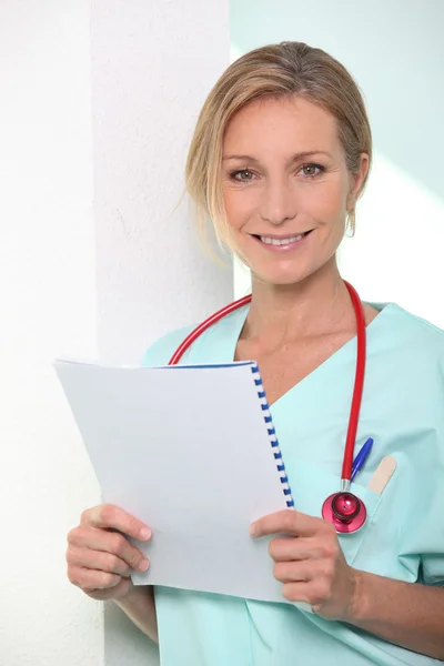 stock image Female medic reading notes