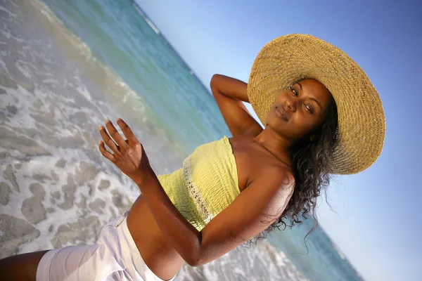 Mulher em um grande chapéu de palha na praia — Fotografia de Stock