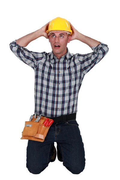 Astonished tradesman with his hands behind his head — Stock Photo, Image