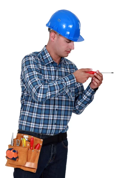 A handyman with a screwdriver. — Stock Photo, Image