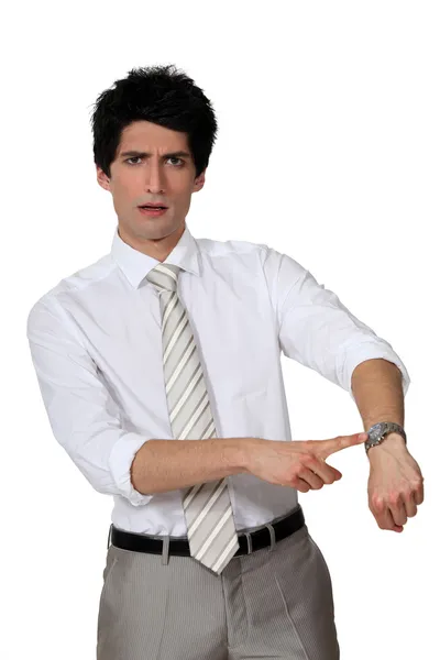 Businessman angrily pointing to his watch — Stock Photo, Image