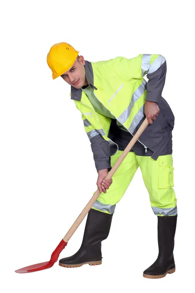 Labourer shovelling — Stock Photo, Image
