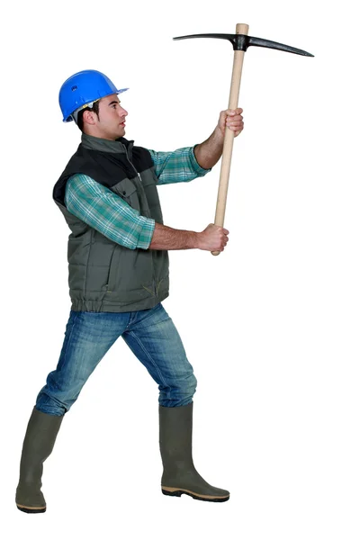 Picture of craftsman holding pickaxe in profile — Stock Photo, Image