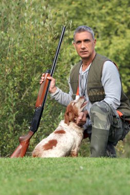 Hunter with shotgun and spaniel clipart