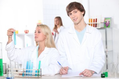 Chemistry students making notes clipart