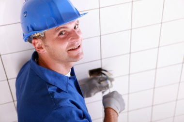 Closeup of an electrician at work clipart