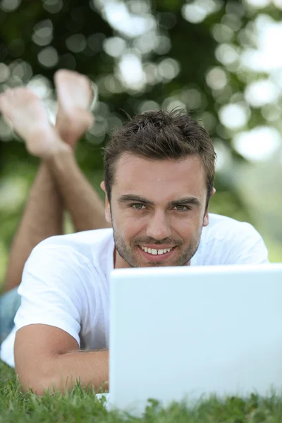 Young man on laptop — Stock Photo, Image