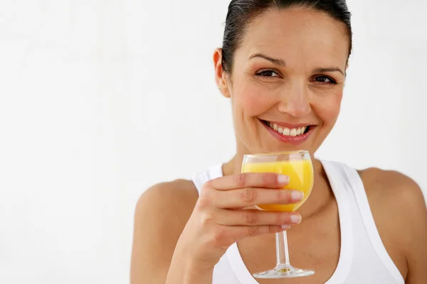 Brunette enjoying glass of orange juice — Stock Photo, Image