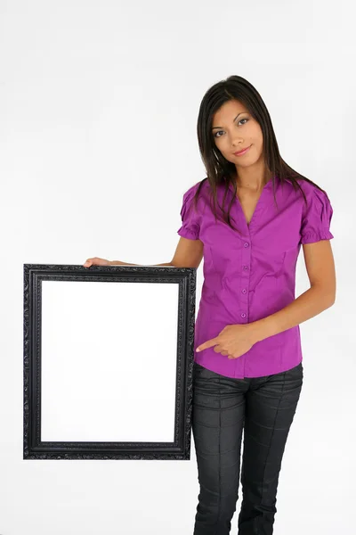 Mujer señalando un marco de imagen — Foto de Stock