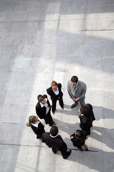 Business team stood in a circle — Stock Photo, Image