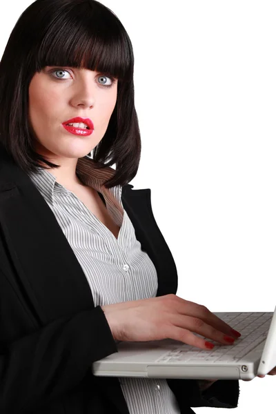 Kvinnan i rött läppstift arbetar på en bärbar dator — Stockfoto