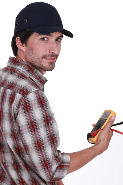 Tradesman holding a multimeter — Stock Photo, Image