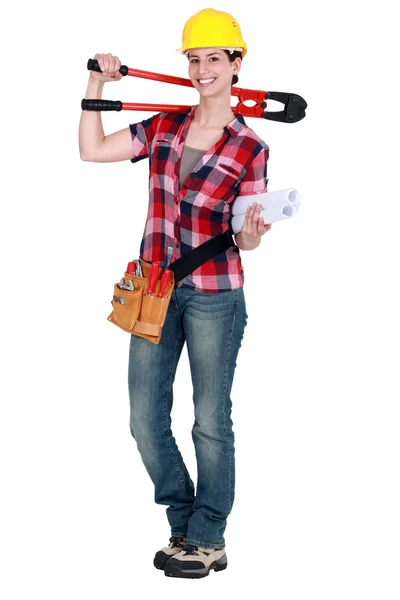 Craftswoman holding spanner and blueprints — Stock Photo, Image