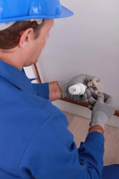 Handyman tightening an adjusting knob. — Stock Photo, Image
