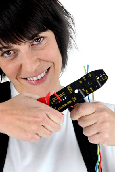 Woman with a wire stripper — Stock Photo, Image