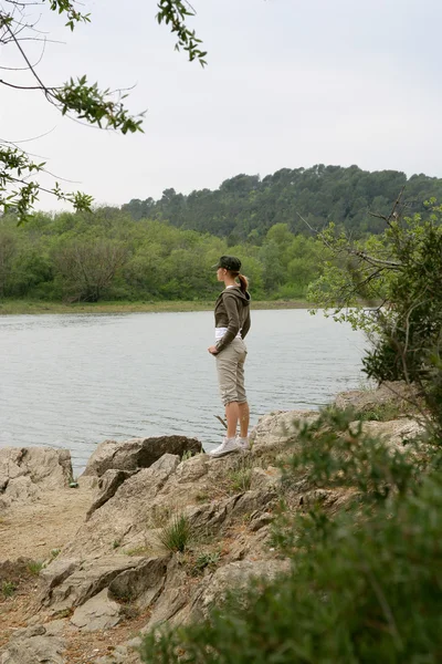 Woman on a riverbank — Stock Photo, Image