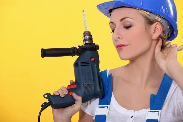 Young woman with an electric drill Royalty Free Stock Images