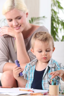 Woman watching her son playing clipart