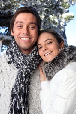 Couple wearing winter clothing clipart