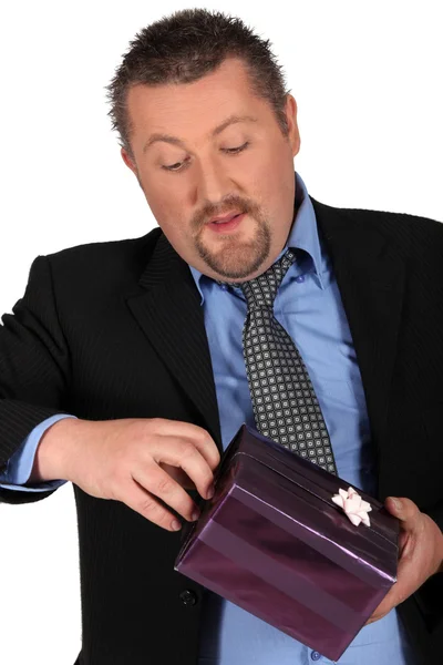 Businessman holding gift — Stock Photo, Image