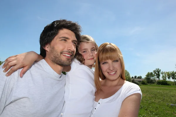Parents with their daughter in a park — Stock Photo, Image